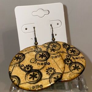Cute round brown wood earrings with hello and flower graphic design